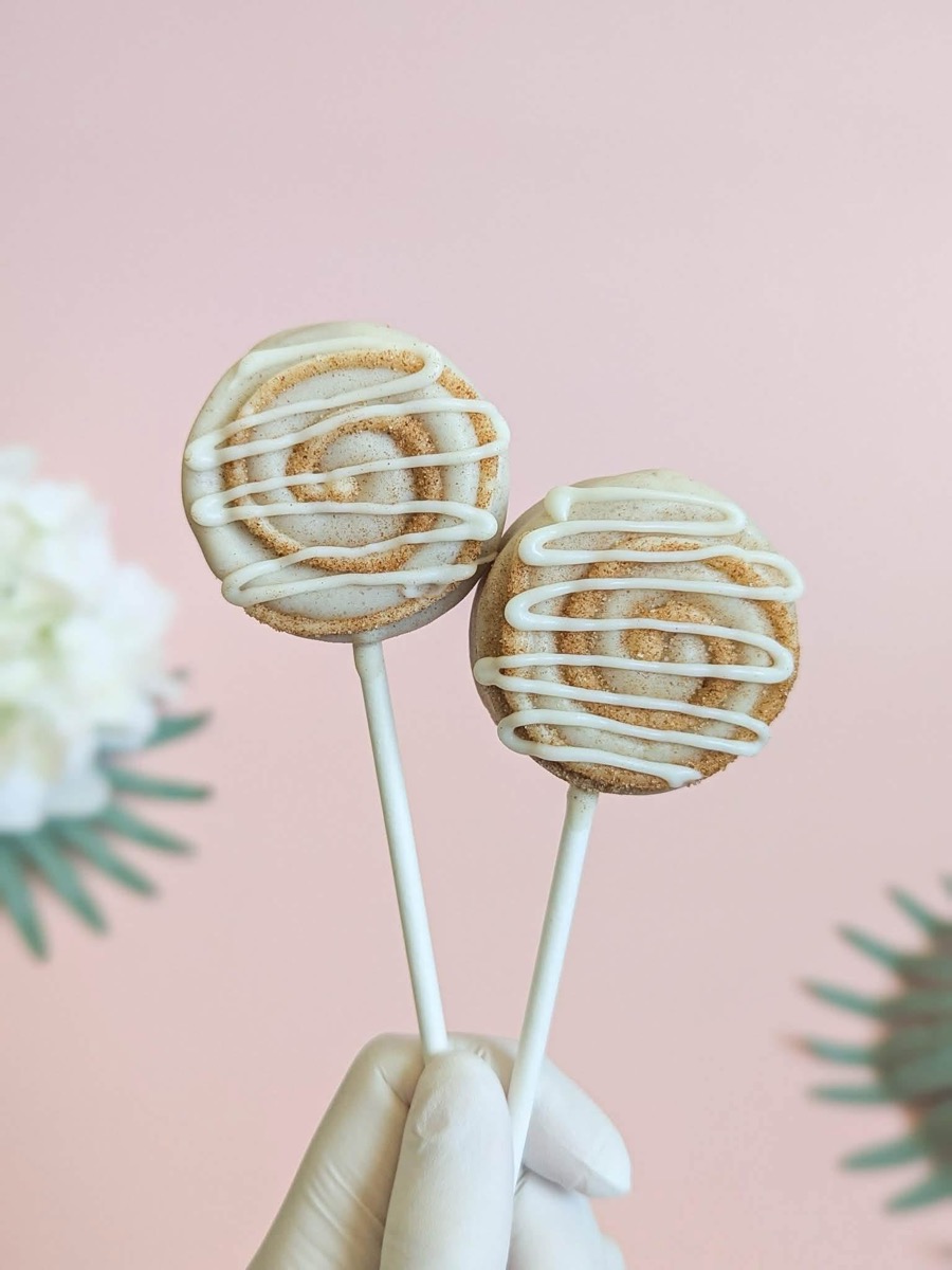 Cinnamon roll cake pops with a cream cheese icing drizzle