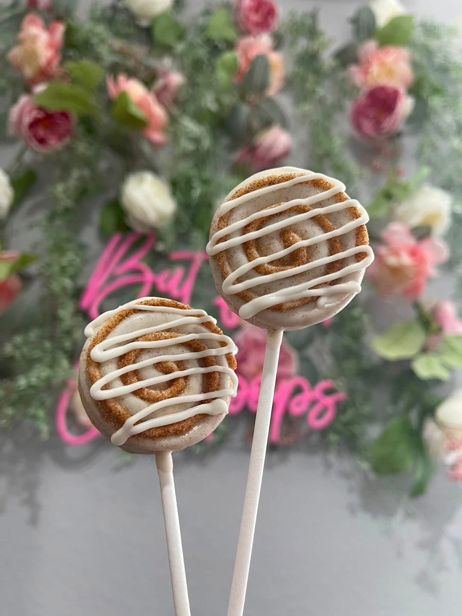 Cinnamon roll cake pops with white icing drizzle