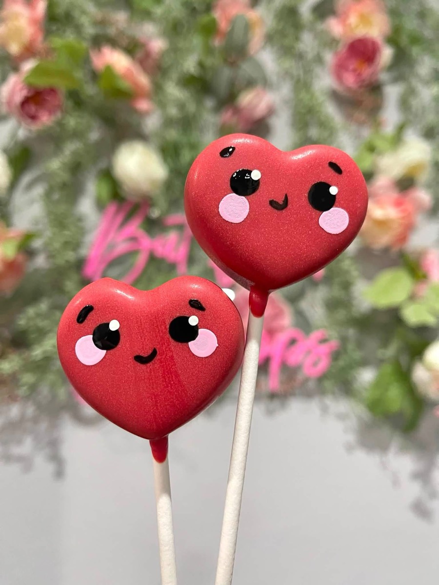 Kawaii heart cake pops with faces in red and pink