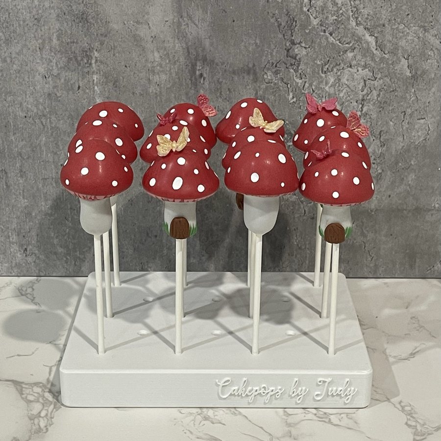 Red toadstool mushroom cake pops with polka dots and bows