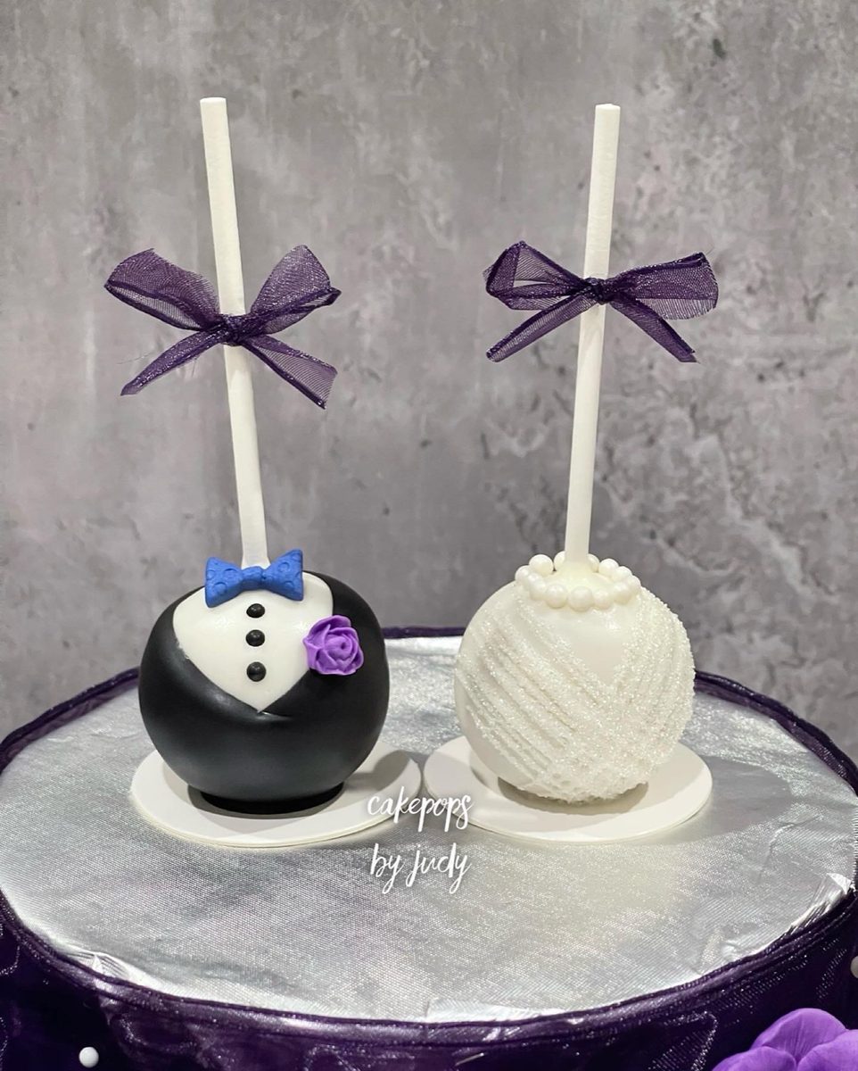Tuxedo groom and lace bride cake pops with purple ribbon bows