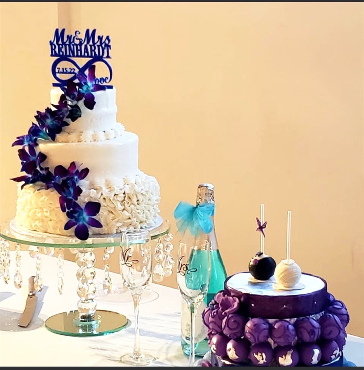 Wedding dessert table with the cake and a purple cake pop display